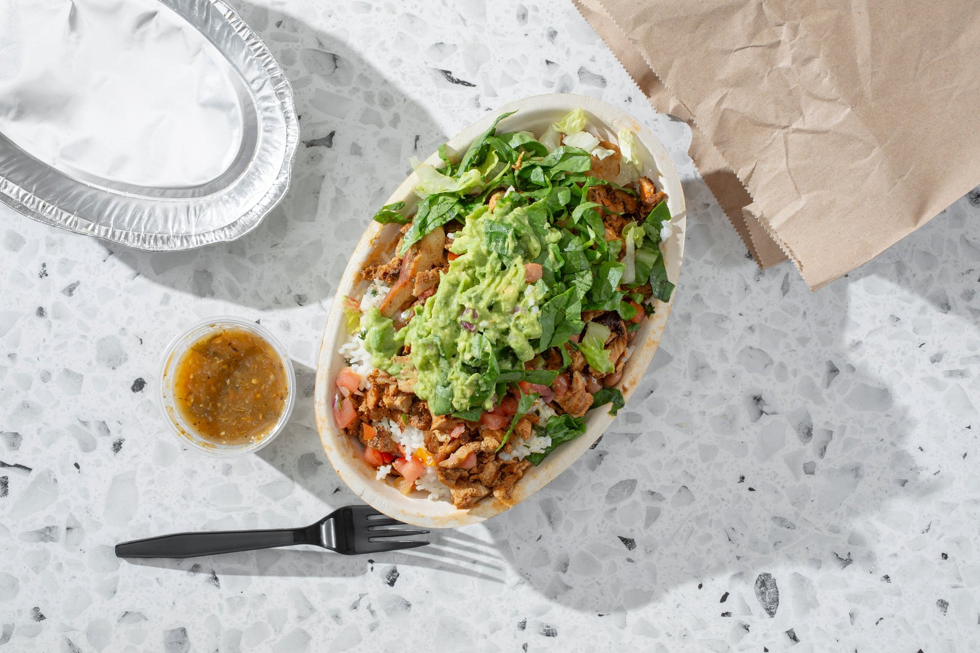 A top down view of a healthy food burrito bowl
