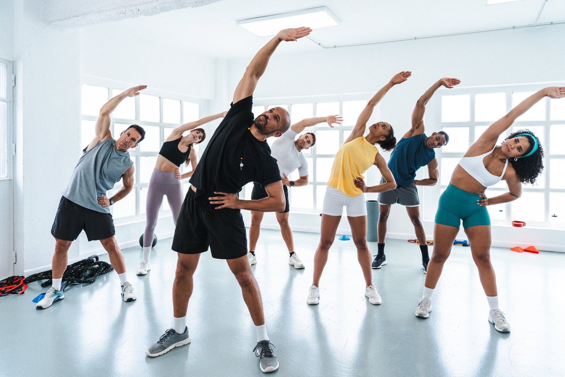 Multiethnic group of sportive people doing functional workout